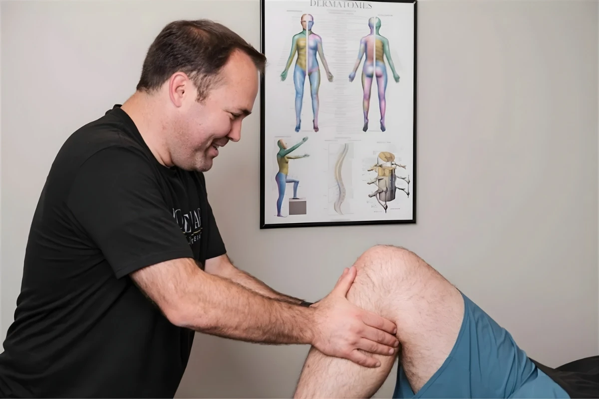 Doctor of Physical Therapy assessing a patient's joint mobility in the Murray clinic