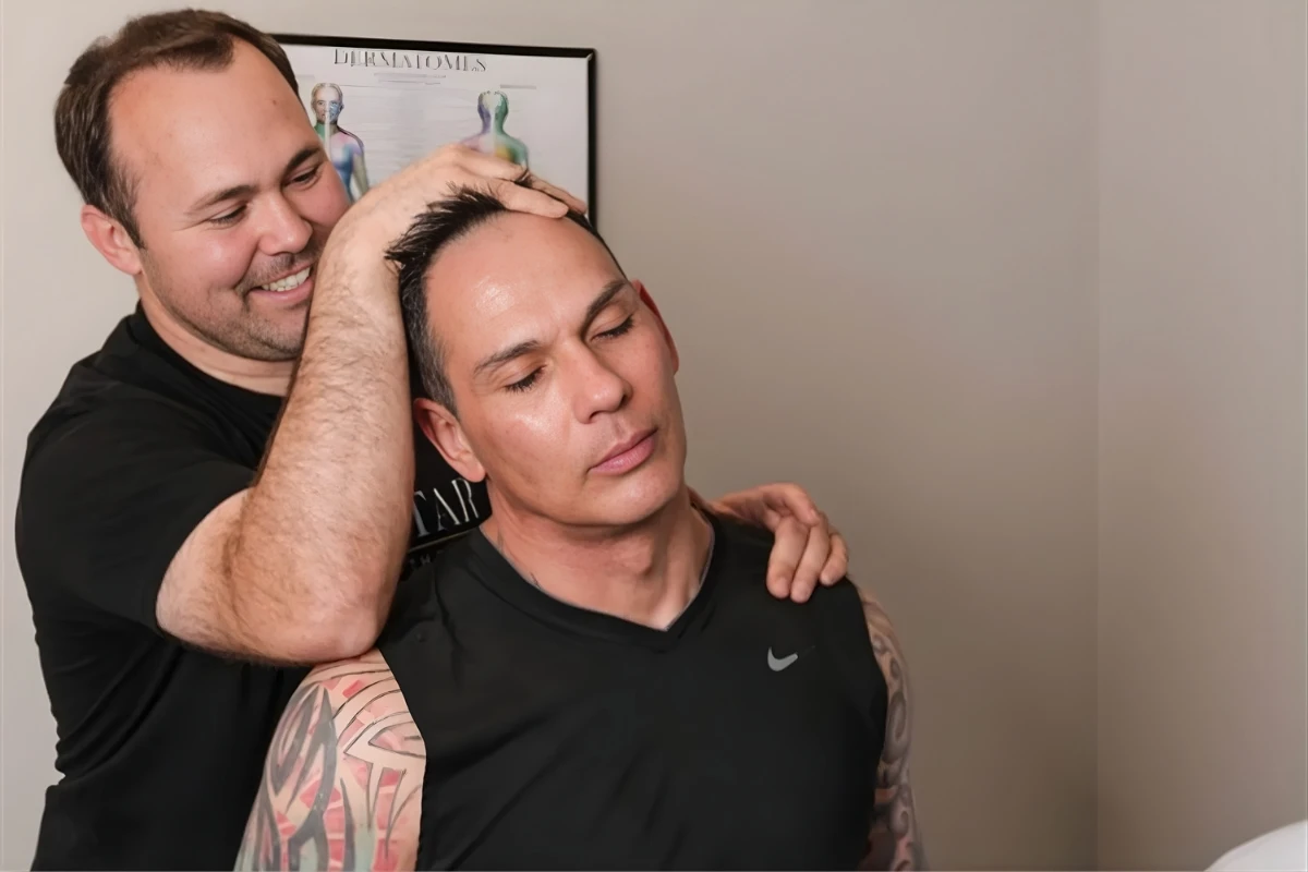 Physical therapist assessing a patient's neck movement and mobility